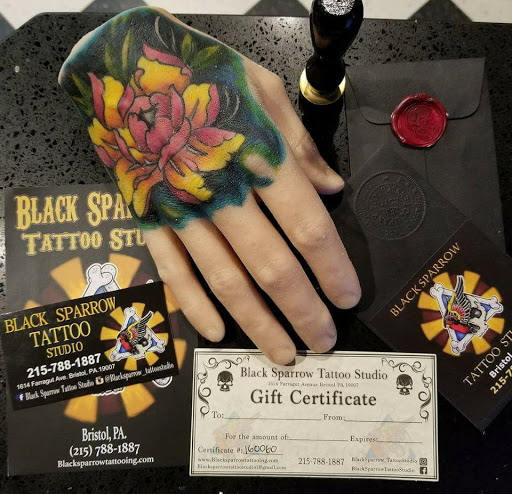 Explore red hand tattoo ideas, creative tattoo ideas in Bristol, available at Black Sparrow Tattoo Studio