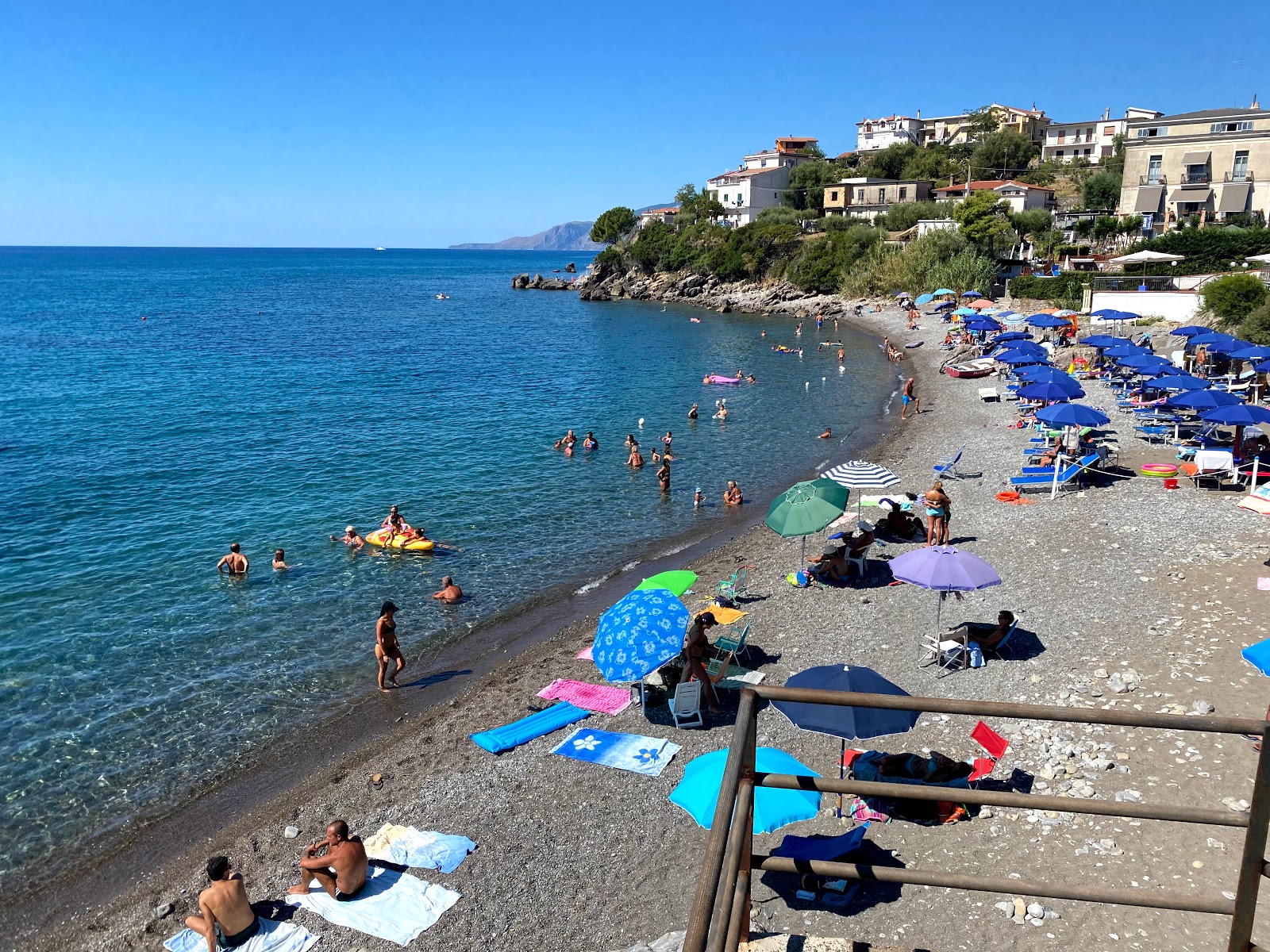 Perla beach'in fotoğrafı kahverengi çakıl yüzey ile