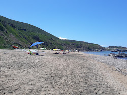 Foto von Spiaggia della Marina di Gutturu ’e Flumini von Klippen umgeben