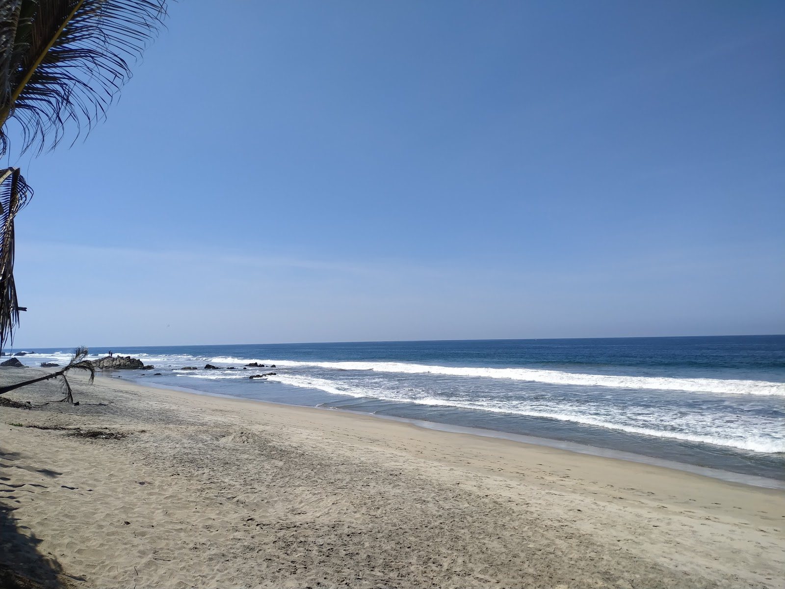 Foto av Playa Tomy med lång rak strand