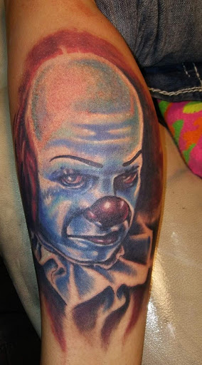 Explore red bird tattoo ideas, creative tattoo ideas in Angola, available at Hoodlum Ink