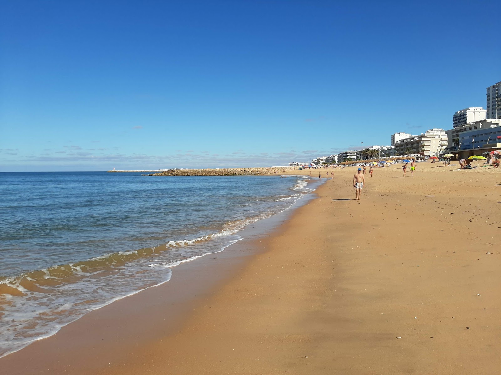 Photo of Praia de Quarteira with long multi bays