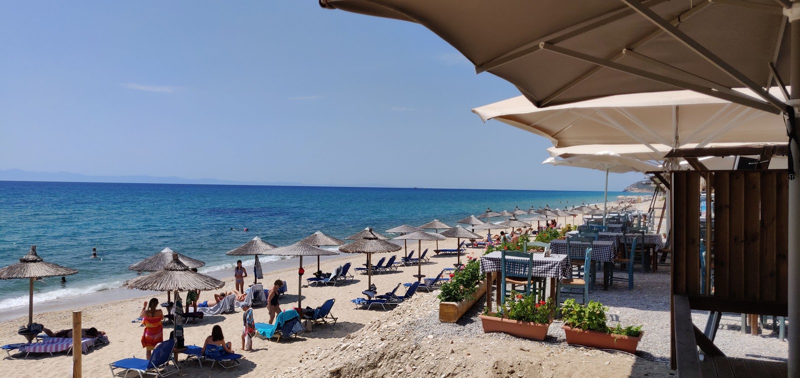 Photo of Aegean beach surrounded by mountains