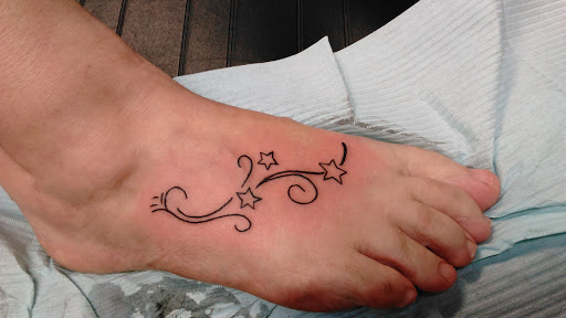 Explore thigh flower tattoo ideas, creative tattoo ideas in Newport, available at T N T Explosive Tattoo