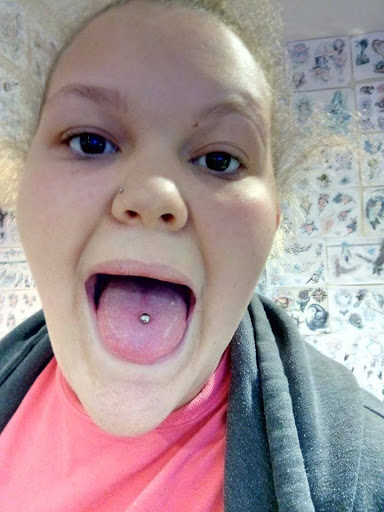 Explore red ink neck tattoo ideas, creative tattoo ideas in Amarillo, available at Illustrated Lady Tattoo & Piercing Studio & School