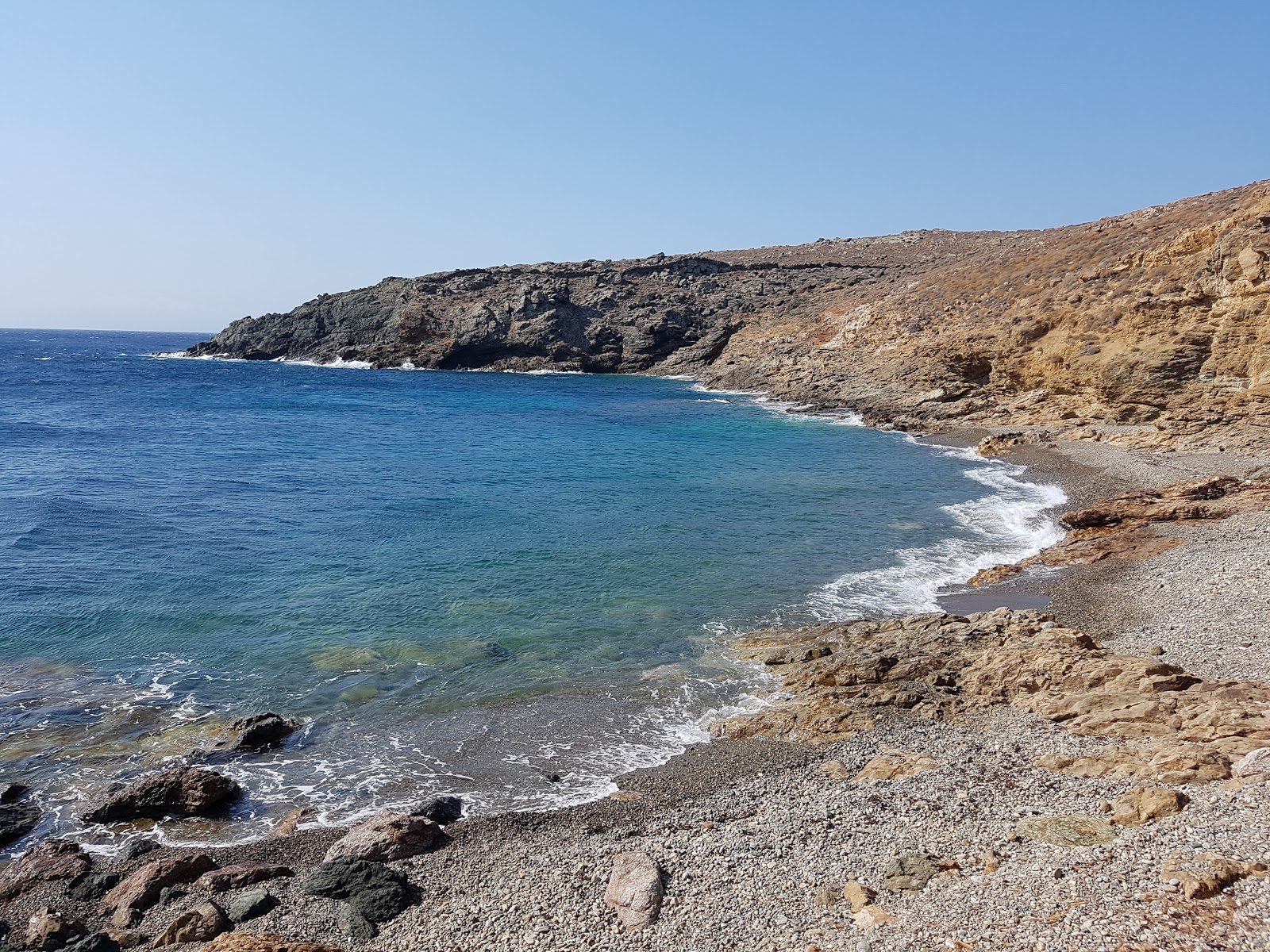 Photo of Paralia Kato Tigani with black sand & pebble surface