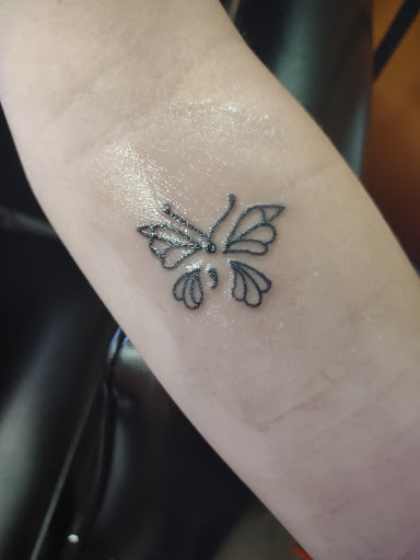 Explore earlobe tattoo ideas, creative tattoo ideas in Williamston, available at Inkd Tattoo Parlor