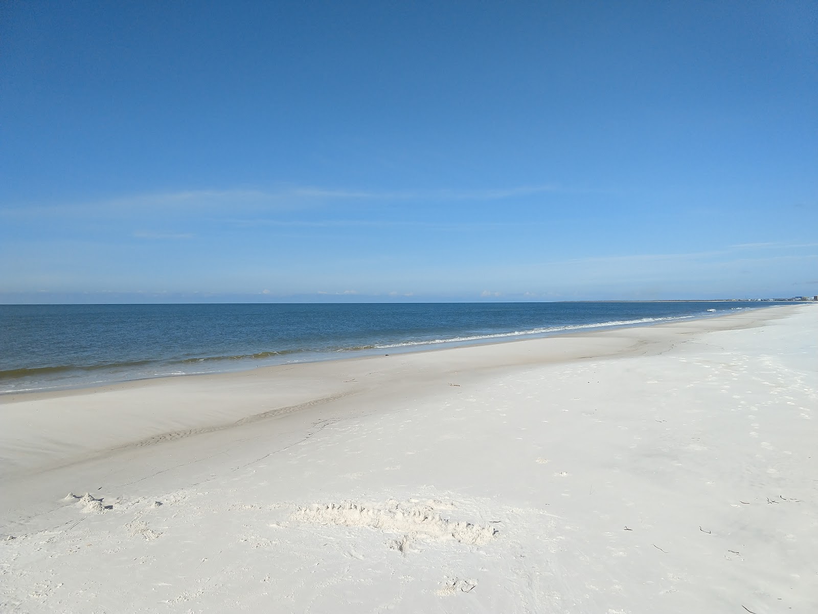 Foto av St. Joe Beach med lång rak strand