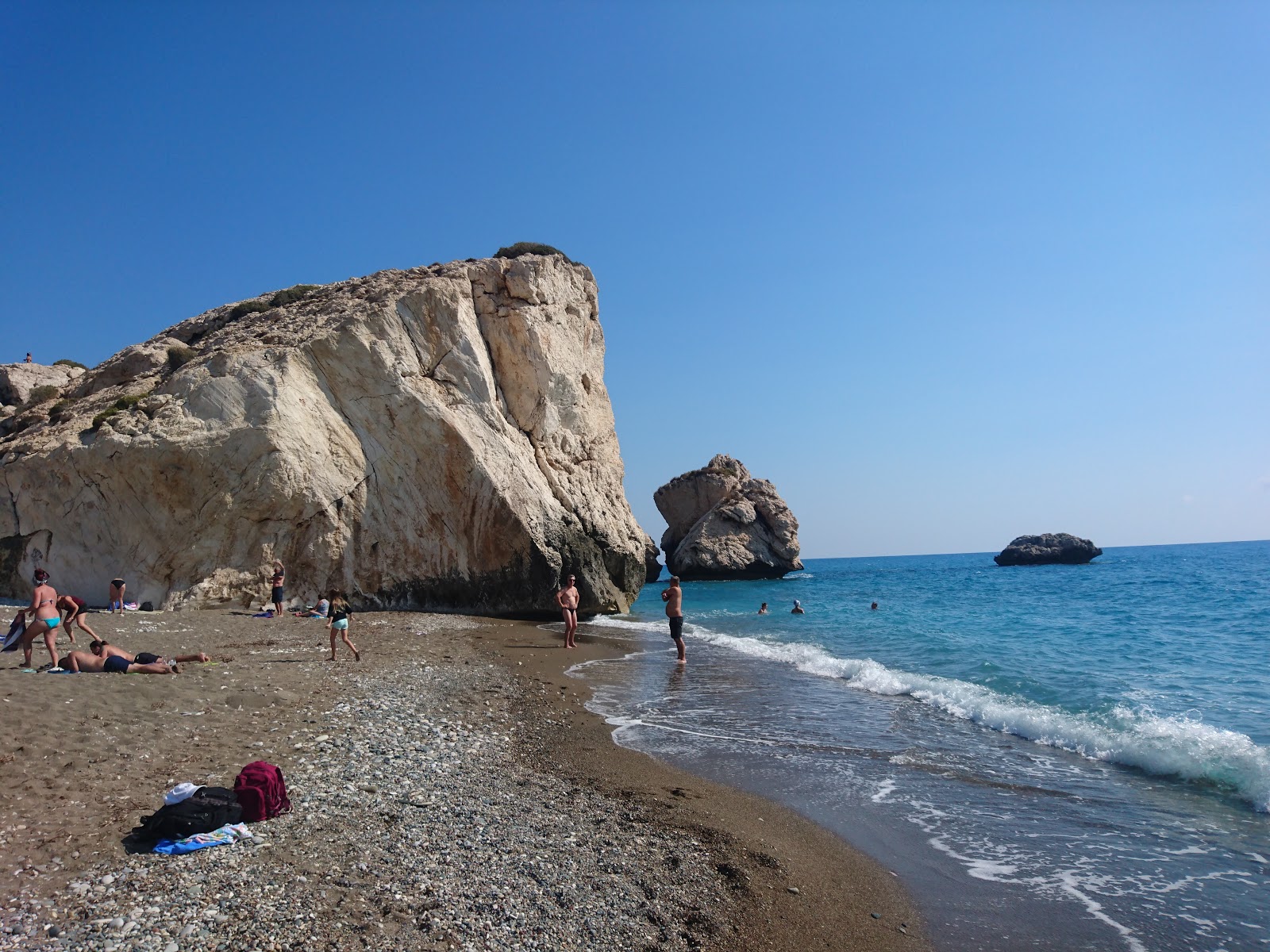 Photo of Aphrodite's rock beach with blue pure water surface