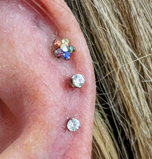 Explore behind ear tattoo ideas, creative tattoo ideas in Toledo, available at Piercings by Caitlin presents Holier Toledo