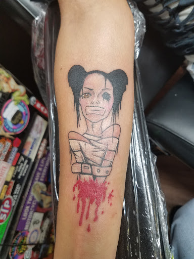 Explore apple tattoo ideas, creative tattoo ideas in Cambridge, available at Skinworks Tattoo