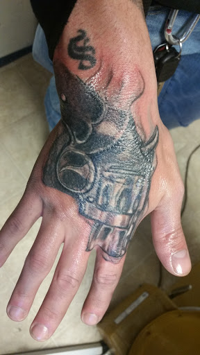 Find lion hand tattoo ideas for men for your next unique tattoo in Cumberland at Queen City Ink