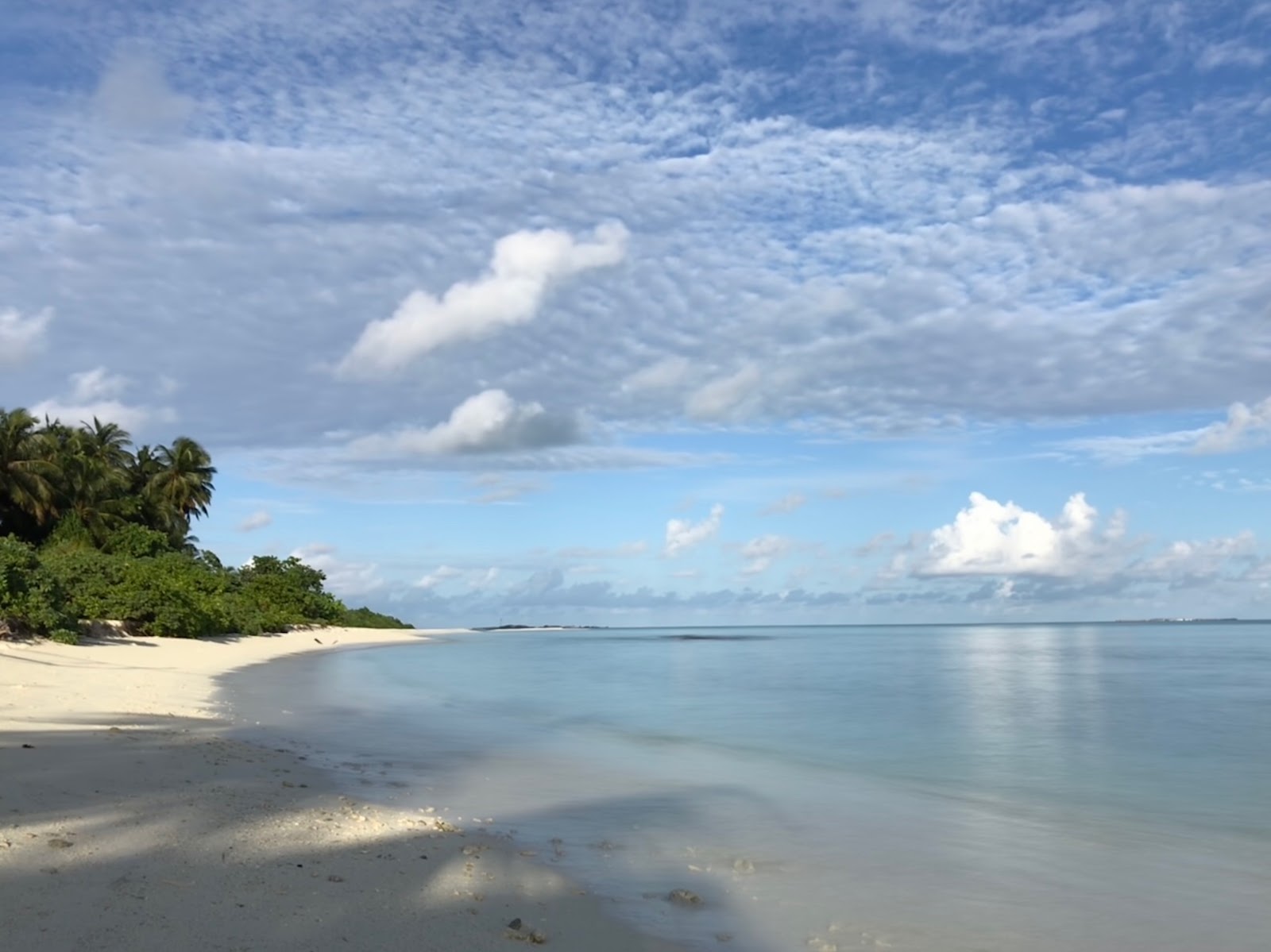 Foto av Fenfushee Island med vit sand yta