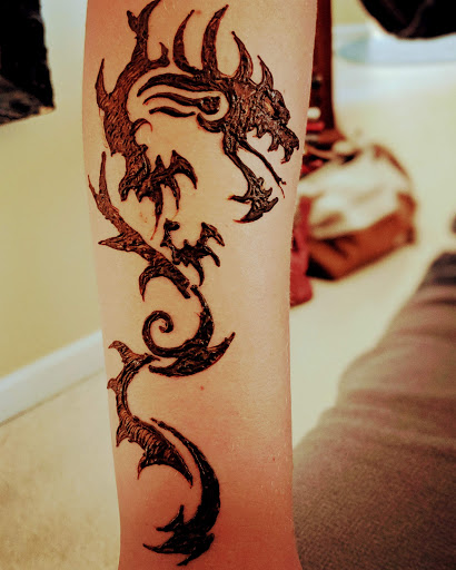 Explore guitar tattoo ideas, creative tattoo ideas in Concord, available at Naseera Fazil Henna Art