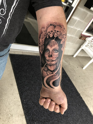 Explore tombstone movie tattoo ideas, creative tattoo ideas in Middletown, available at Traditionally Twisted Tattoo