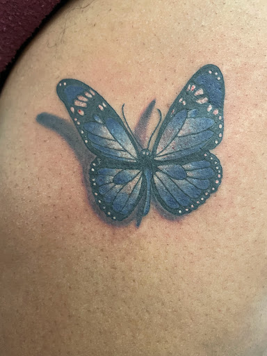 Find women's rib tattoo ideas for your next unique tattoo in Jamaica at Rising Phoenix Ink