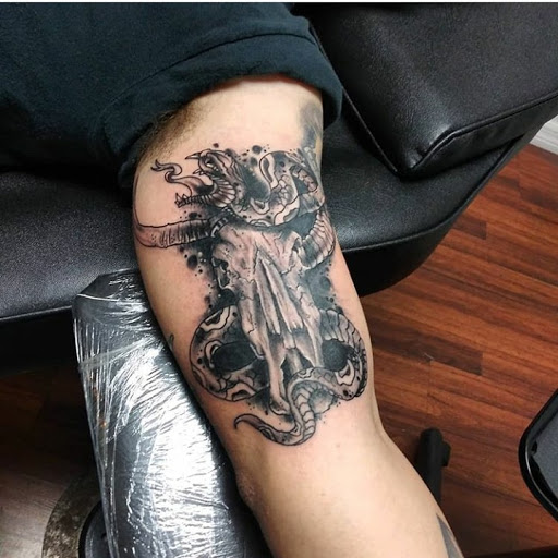 Explore ribbon tattoo ideas, creative tattoo ideas in Atlantic Beach, available at The Ink Chamber Tattoo Parlor