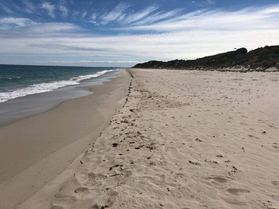 Valokuva Peppermint Beachista. pinnalla turkoosi puhdas vesi:n kanssa