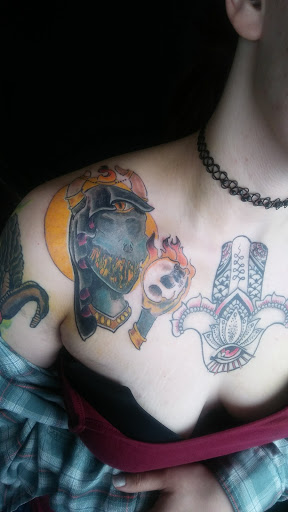 Explore ripped skin tattoo ideas, creative tattoo ideas in Loveland, available at Sanctum Tattooing