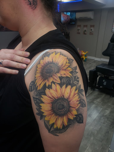Find tattoo ideas for in between breast for your next unique tattoo in Linn Creek at Hillard Skillard Tattoos, LLC.