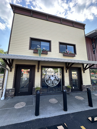 Find in between breast tattoo ideas for your next unique tattoo in Canton at Brass Heart Tattoo