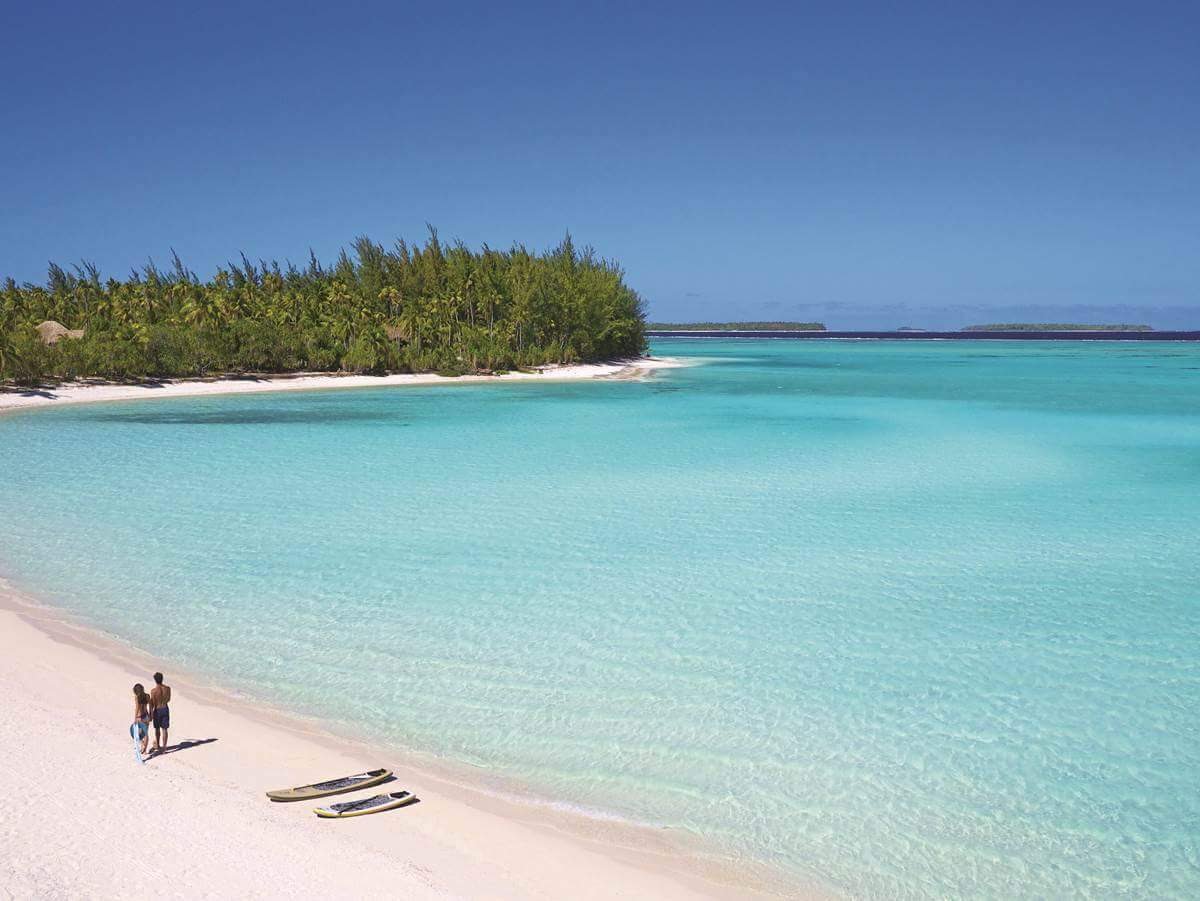 Foto di Spiaggia dell'isola di Onetahi con una superficie del sabbia pura bianca