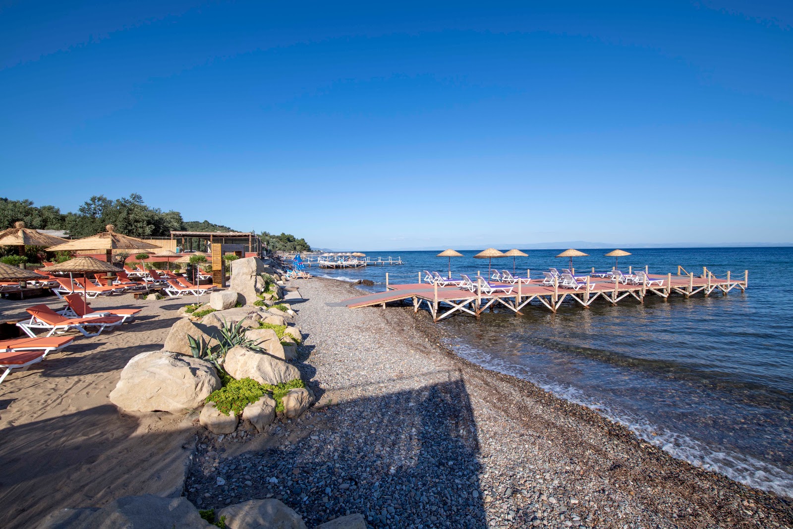 Photo of Assos Club beach with light pebble surface