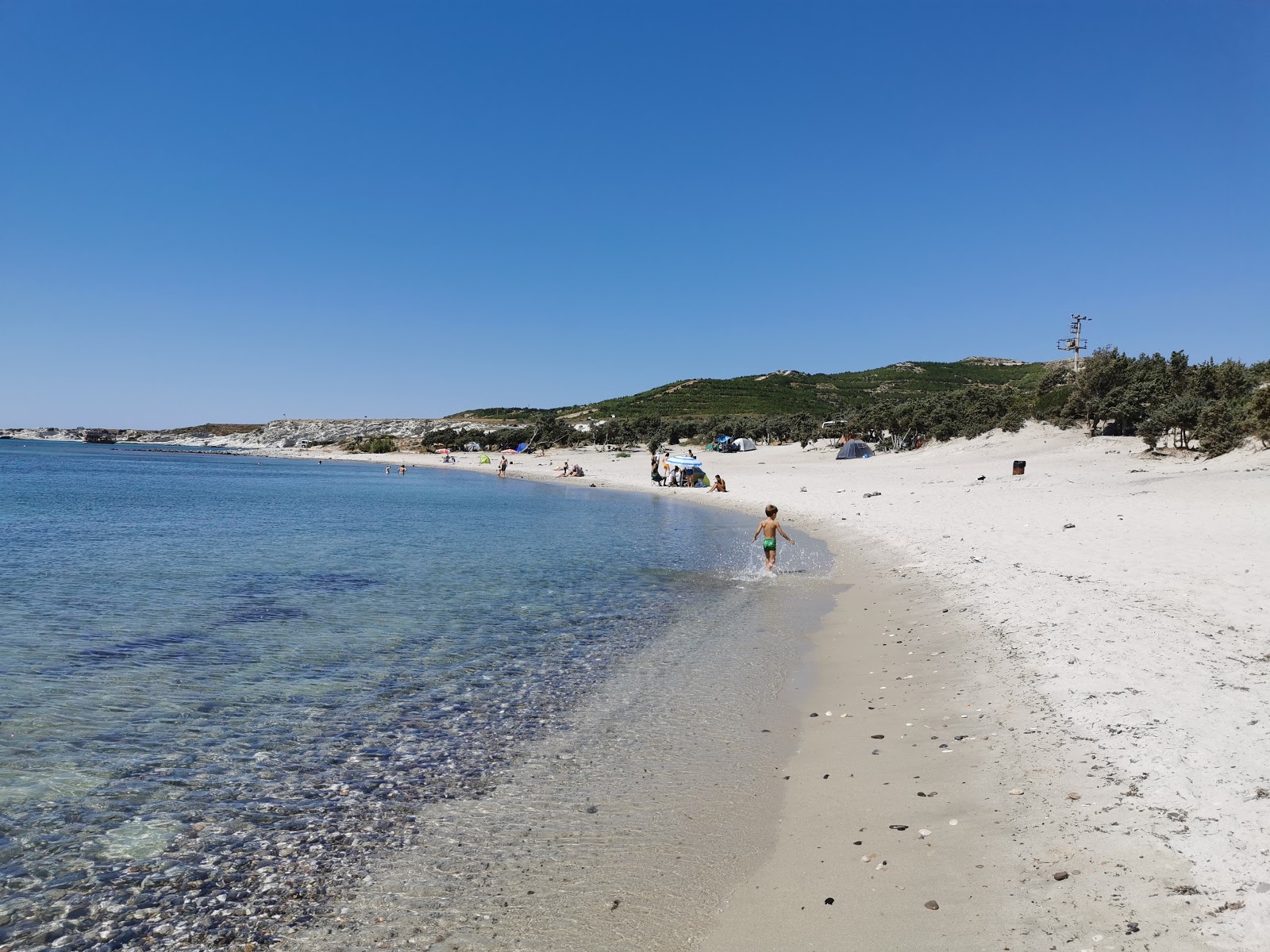 Valokuva Gilikli Halk Plajiista. pinnalla kevyt hiekka ja kivi:n kanssa