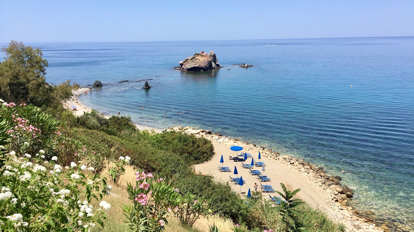 Photo of Aphrodite's beach with rocks cover surface