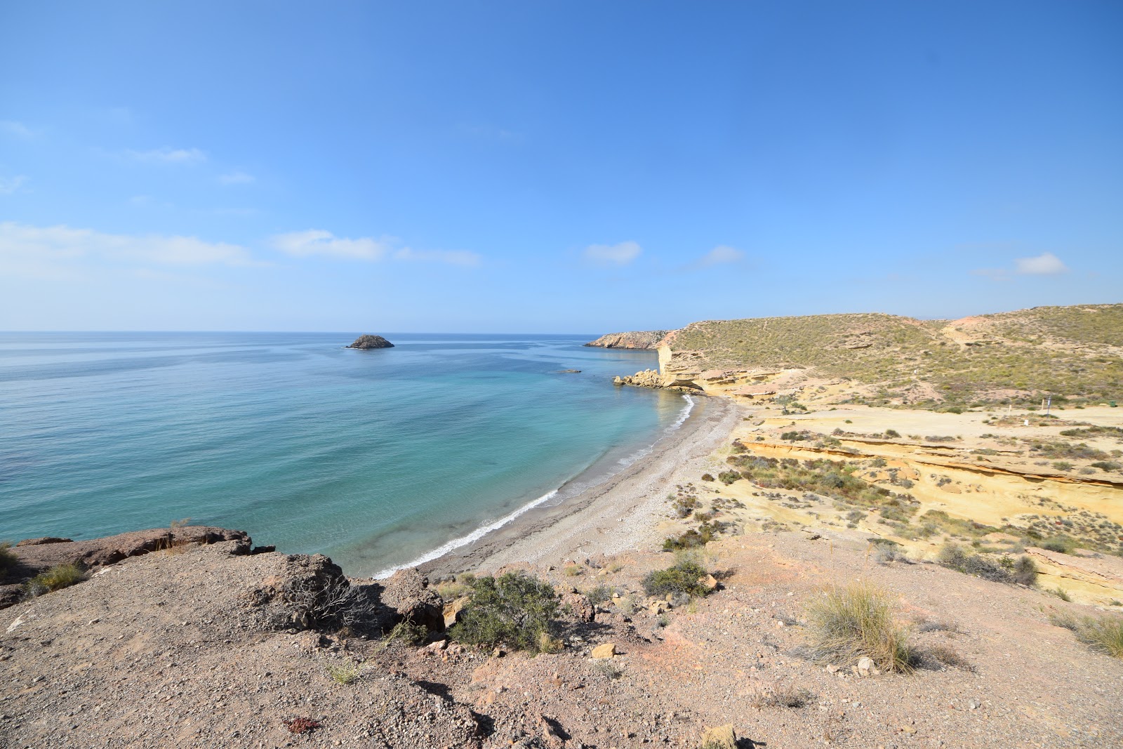 Photo of Playa Cueva de Lobos with brown sand &  rocks surface