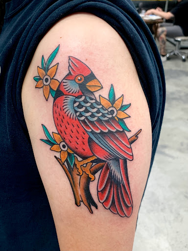 Explore thigh flower tattoo ideas, creative tattoo ideas in Orange, available at Black Palm Tattoo