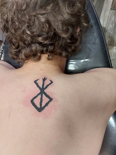 Explore negative space tattoo ideas, creative tattoo ideas in Foley, available at Black Sheep Custom Tattoos and Piercings