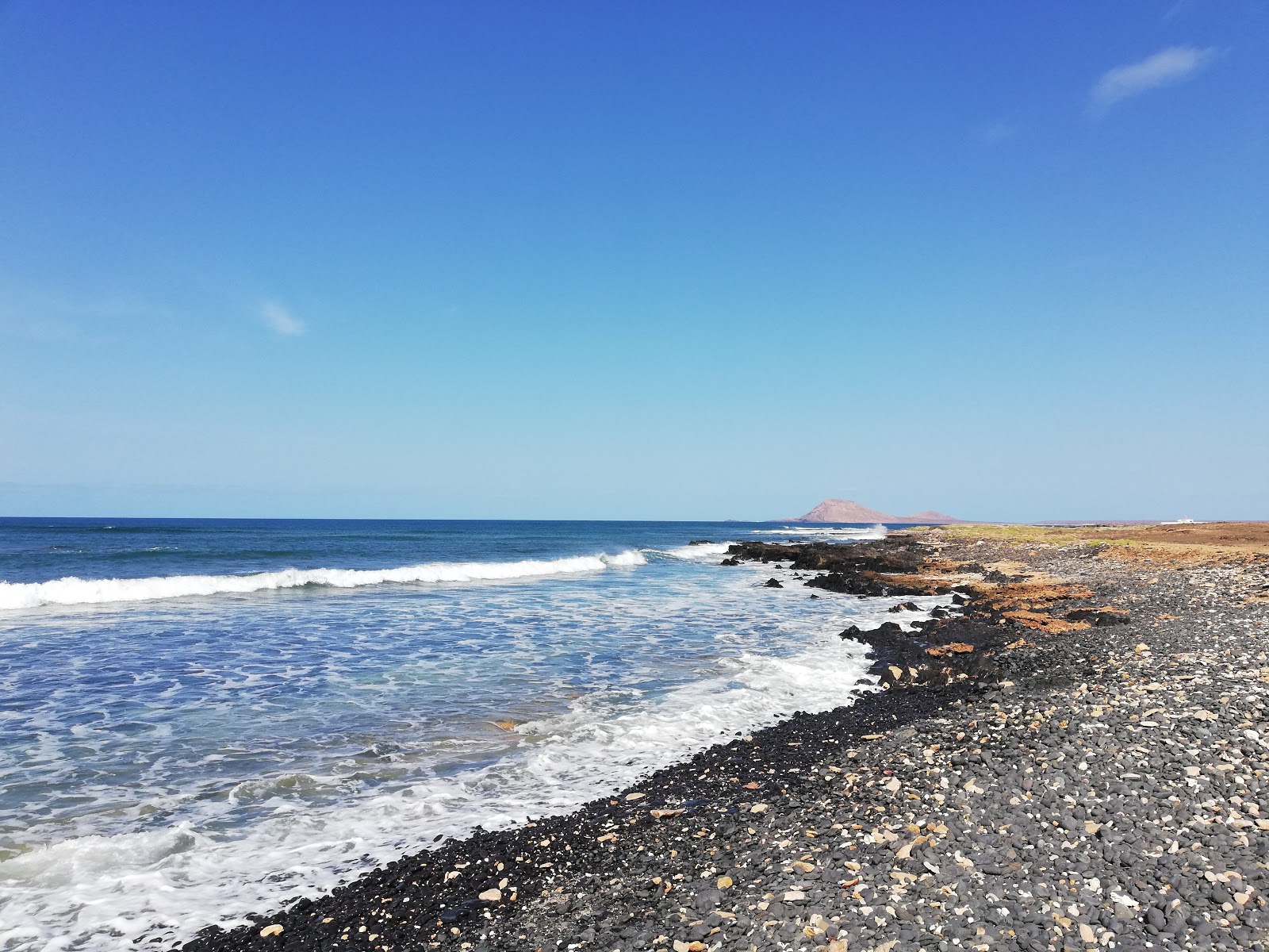 Photo of Black Beach with gray sand &  rocks surface