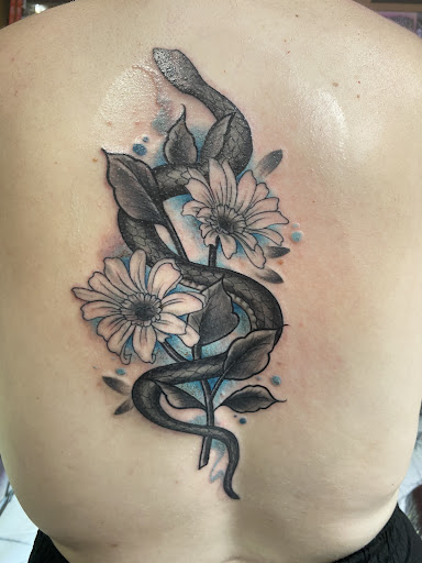 Find in between boob tattoo ideas for your next unique tattoo in Titusville at Exclusive Ink Studio