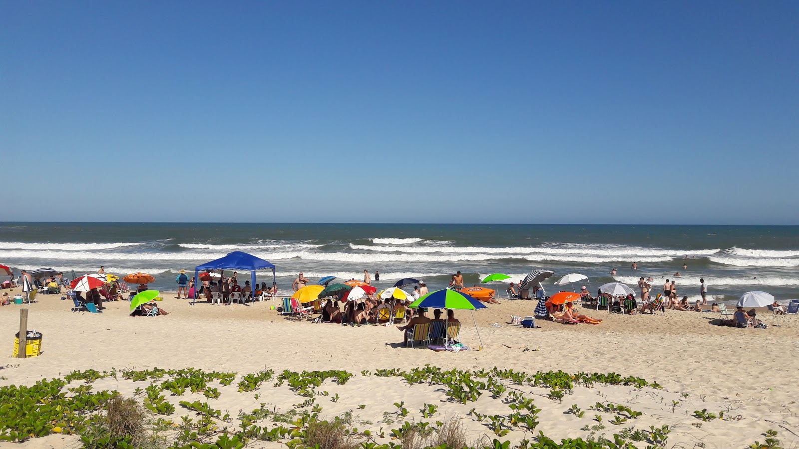 Foto van Praia da Ferrugem ondersteund door kliffen