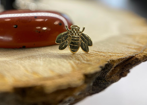 Explore honey bee tattoo ideas, creative tattoo ideas in Dover, available at Agap Body Piercings
