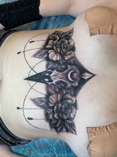 Find tattoos under the breast ideas for your next unique tattoo in Houston at The Neon Jackal Tattoo