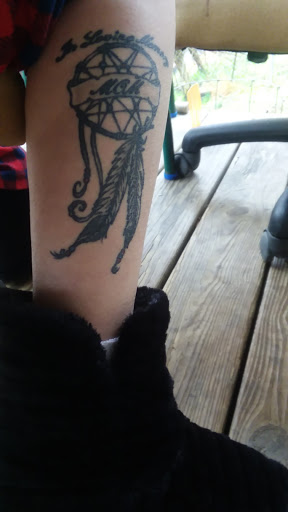 Explore lung cancer ribbon tattoo ideas, creative tattoo ideas in Pikeville, available at The Carbon Canary Tattoo Studio