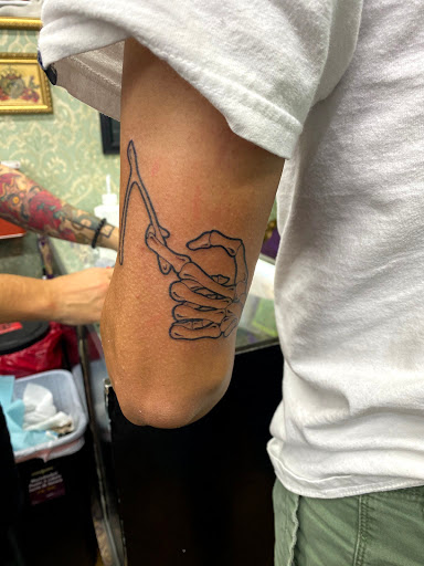 Explore bicep tattoo ideas men, creative tattoo ideas in Miami, available at Green Machine Tattoos & Body Piercing