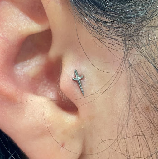 Explore female hand tattoo ideas, creative tattoo ideas in Orange, available at Symbiosis Body Piercing