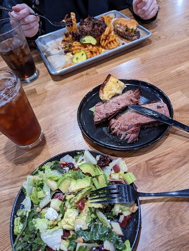 Laura Salad with brisket, Waffle cheese fries with brisket and a Smashburger.