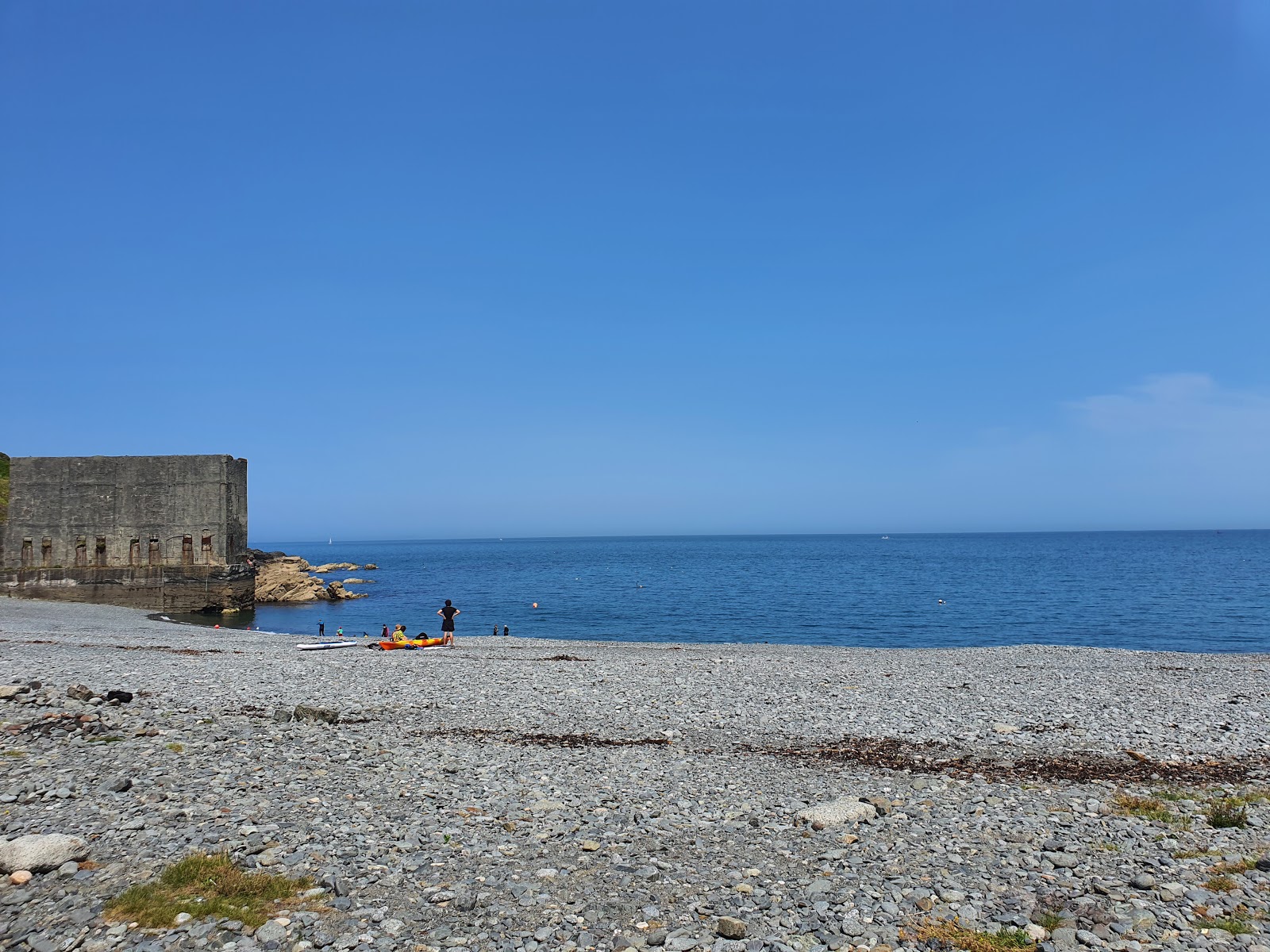 Fotografie cu Porthoustock beach cu o suprafață de apa pură turcoaz