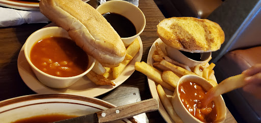 Garlic bread, steak fries, baked beans and sauce