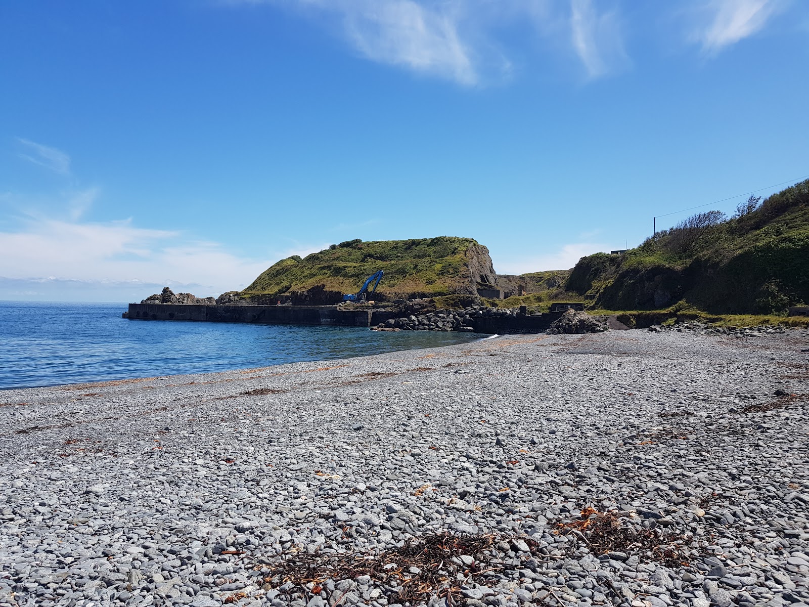 Porthoustock beach的照片 带有宽敞的海湾