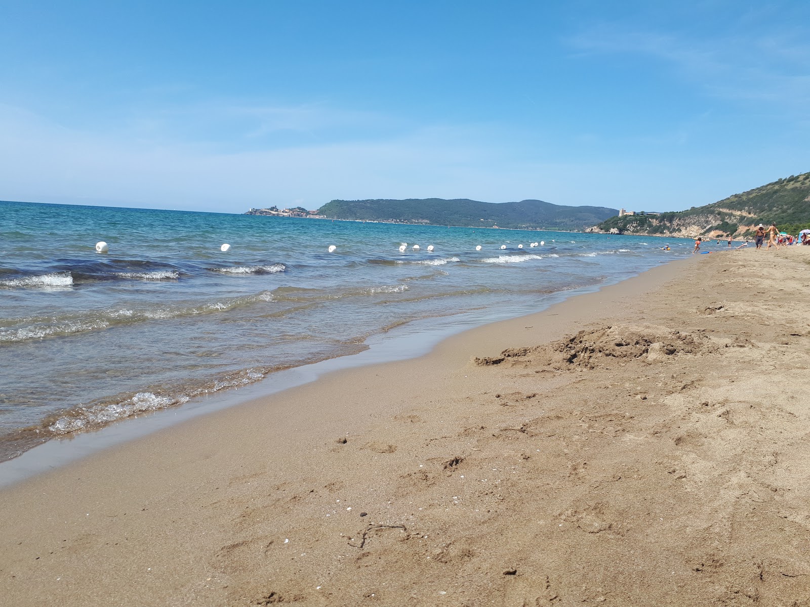 Valokuva Spiaggia Dell'Osaista. pinnalla sininen vesi:n kanssa