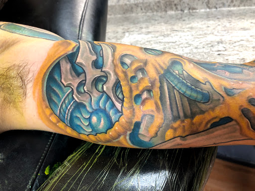 Explore mens knee tattoo ideas, creative tattoo ideas in Sarasota, available at SEVEN SINS Tattoo Studio