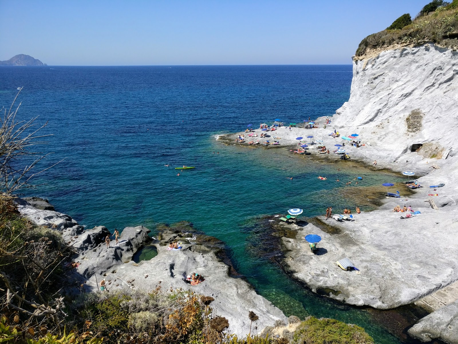 Photo of La Caletta with blue pure water surface