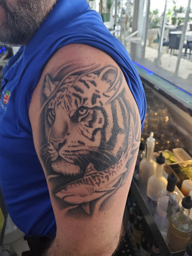 Explore michigan football tattoo ideas, creative tattoo ideas in Pompano Beach, available at In the Flesh Tattoo Co.