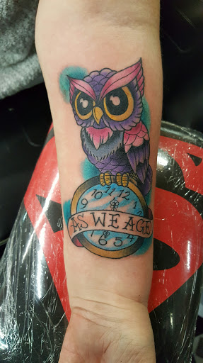 Explore minimalist tattoo ideas for men, creative tattoo ideas in Prince Frederick, available at Red Octopus Tattoos