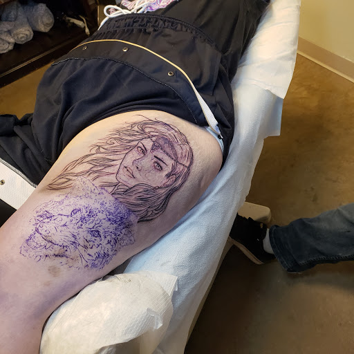Explore mens quad tattoo ideas, creative tattoo ideas in Tea, available at Red Arbor Tattoo